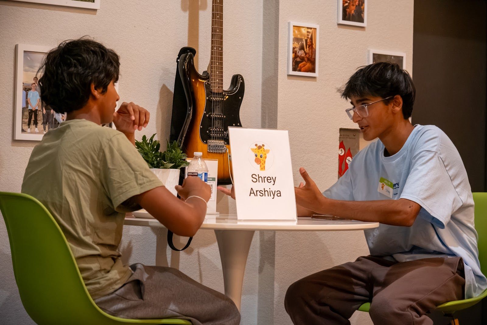 Two teens talking at a table